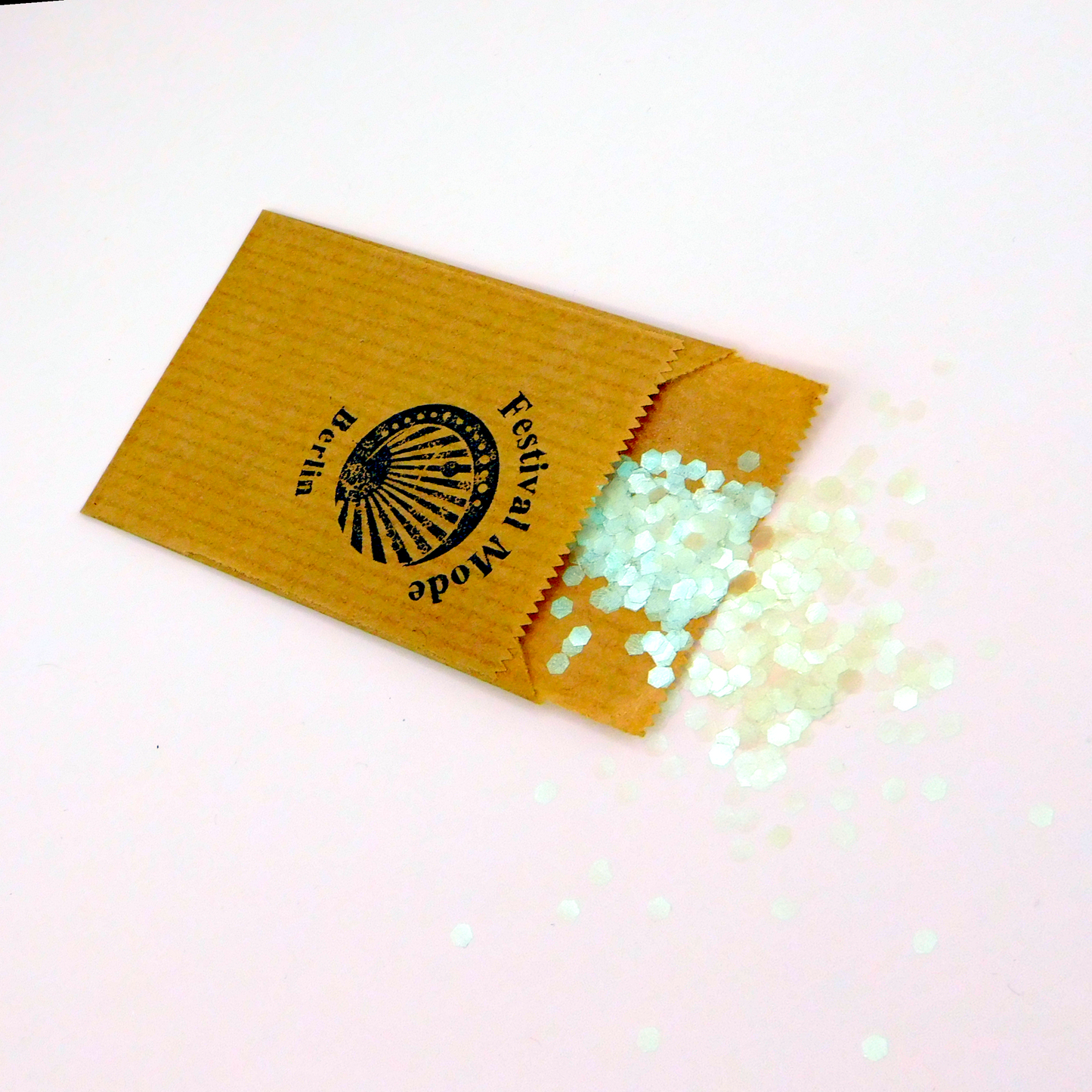 Lucid green grün bioglitzer spilled out from paper package