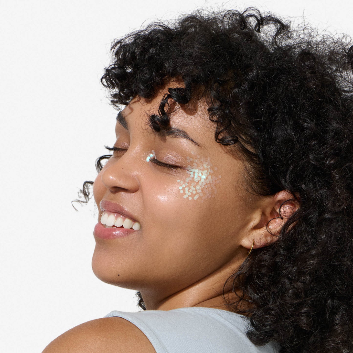 Smiling and relaxed face of woman wearing lucid green bioglitter